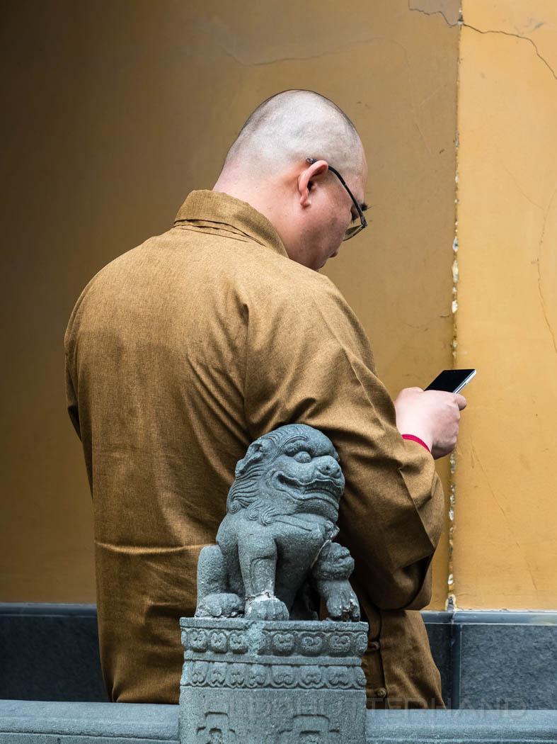 monk with cellphone