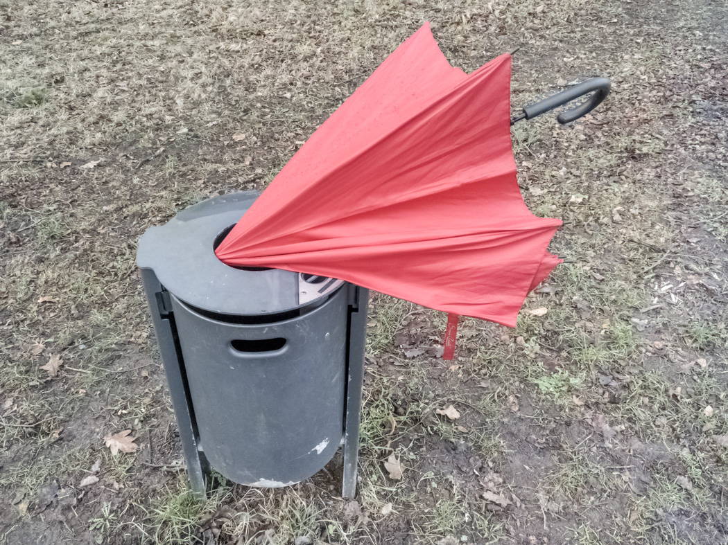 Umbrella in a dustbin